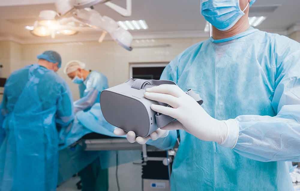 Doctor in a surgical room with virtual reality glasses on the background of the real operation